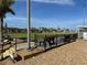 Outdoor lawn bowling area with manicured grass, seating, and clear markings for an engaging game at 1531 Council Dr, Sun City Center, FL 33573