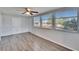 Cozy room featuring gray wood floors, natural light, and a ceiling fan at 1531 Council Dr, Sun City Center, FL 33573