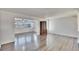 Bright living room with gray wood floors, ceiling fan, and china cabinet at 1531 Council Dr, Sun City Center, FL 33573