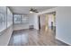 Bright living room with neutral walls, updated ceiling fan and sleek gray wood flooring at 1531 Council Dr, Sun City Center, FL 33573