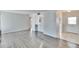 Open-concept living space featuring neutral paint and modern gray flooring at 1531 Council Dr, Sun City Center, FL 33573