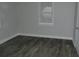 Empty bedroom with gray walls, a window, and modern wood-look floors at 1736 14Th N St, St Petersburg, FL 33704