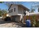 Exterior view of a home with gray siding and a stairway entrance at 1736 14Th N St, St Petersburg, FL 33704