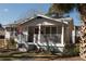 Front elevation of house with porch and railing, and gray exterior paint at 1736 14Th N St, St Petersburg, FL 33704