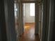 Hallway with hardwood floors and doorways leading to different rooms of the house at 1736 14Th N St, St Petersburg, FL 33704