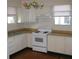 Functional kitchen with white cabinets, wooden countertop, and classic appliances at 1736 14Th N St, St Petersburg, FL 33704