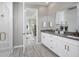 Serene bathroom with double vanity, stone countertops, glass-enclosed shower, and modern fixtures at 18483 Green Garden Ct, Venice, FL 34293