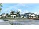 Exterior view of community buildings with modern design, lush landscaping, and convenient parking at 18483 Green Garden Ct, Venice, FL 34293