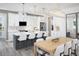 Modern eat-in kitchen featuring white cabinets, stainless steel appliances, a large island, and stylish pendant lighting at 18483 Green Garden Ct, Venice, FL 34293