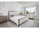 Elegant main bedroom with tray ceiling, lots of natural light, neutral colors, and stylish furnishings at 18483 Green Garden Ct, Venice, FL 34293