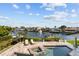 Backyard featuring a pool, hot tub, and picturesque water views from a two-story home at 1930 Kansas Ne Ave, St Petersburg, FL 33703