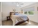 Cozy bedroom with natural light, a ceiling fan, and a window view of the lush surrounding greenery at 1930 Kansas Ne Ave, St Petersburg, FL 33703