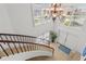 Bright foyer with a curved staircase and beautiful dark wood railings, complemented with shutters for lots of light at 1930 Kansas Ne Ave, St Petersburg, FL 33703