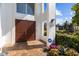 Elegant front entrance with double doors, brick walkway, white pillars, and manicured landscaping at 1930 Kansas Ne Ave, St Petersburg, FL 33703