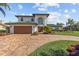 Stunning two-story home featuring a manicured lawn, brick driveway and a two-car garage at 1930 Kansas Ne Ave, St Petersburg, FL 33703