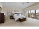 Tranquil main bedroom with tray ceilings, plush carpeting, and large windows with a view at 1930 Kansas Ne Ave, St Petersburg, FL 33703