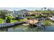 Waterfront home with a private dock, boat lift, and lush tropical landscaping in the backyard at 1930 Kansas Ne Ave, St Petersburg, FL 33703