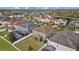 Aerial view of backyard, screened-in patio, and the surrounding homes with a community lake at 19429 Paddock View Dr, Tampa, FL 33647