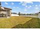 View of the backyard showing green grass and a pond view at 19429 Paddock View Dr, Tampa, FL 33647