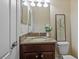 Bathroom with a granite countertop, updated fixtures, and decorative flower vase at 19429 Paddock View Dr, Tampa, FL 33647