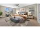 Staged bedroom featuring a large bed, modern decor, and natural light at 19429 Paddock View Dr, Tampa, FL 33647