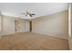 Large bedroom with neutral carpet and a ceiling fan at 19429 Paddock View Dr, Tampa, FL 33647