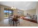 Bright dining area boasts tile floors, wood table with seating, and a sliding door to the screened porch overlooking the water at 19429 Paddock View Dr, Tampa, FL 33647