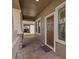 Covered front porch featuring brick flooring, stone columns, and a welcoming entrance at 19429 Paddock View Dr, Tampa, FL 33647