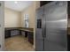 Bright kitchen area with stainless steel refrigerator and desk area with granite countertops at 19429 Paddock View Dr, Tampa, FL 33647