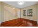 Bright living room with gleaming hardwood floors, neutral walls, and a staircase to the upper level at 19429 Paddock View Dr, Tampa, FL 33647