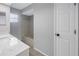 Bathroom featuring a tub, white door, quartz countertop, and neutral color palette at 2609 Ridge Ln, Palm Harbor, FL 34684