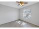 Bedroom featuring tile floors, a ceiling fan, and a window with natural light at 2609 Ridge Ln, Palm Harbor, FL 34684