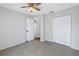 Bedroom with tiled floors, a ceiling fan, and a closet for ample storage space at 2609 Ridge Ln, Palm Harbor, FL 34684