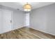 Bedroom with laminate floors, neutral wall color, and modern light fixture at 2609 Ridge Ln, Palm Harbor, FL 34684