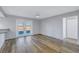 This is a well-lit living room featuring laminate floors, a ceiling fan and French doors at 2609 Ridge Ln, Palm Harbor, FL 34684