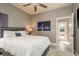 Bedroom with a plush white bed and a view of the outdoor seating through a door at 2619 Ravendale Ln, Holiday, FL 34691