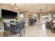 Open-concept dining room featuring modern lighting, sleek flooring, and seamless flow to the outdoor patio at 2619 Ravendale Ln, Holiday, FL 34691