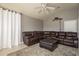 Comfortable living room featuring a large sectional couch, ottoman, and neutral colored walls at 2619 Ravendale Ln, Holiday, FL 34691