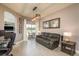 Bright living room with neutral tones, leading to an outdoor patio, adjacent to an office area for work at 2619 Ravendale Ln, Holiday, FL 34691