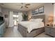 Bright main bedroom features an ensuite, ceiling fan, and sliding glass doors to the outdoors at 2619 Ravendale Ln, Holiday, FL 34691