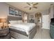 Spacious main bedroom features a ceiling fan, ensuite, and neutral color palette at 2619 Ravendale Ln, Holiday, FL 34691