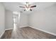 Neutral bedroom has wood-look floors and is situated off the hallway at 2914 Westmoreland Ct, New Port Richey, FL 34655