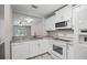 Modern kitchen with stainless steel appliances and a view into the living area at 2914 Westmoreland Ct, New Port Richey, FL 34655