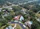 An aerial view showing homes in a residential neighborhood with mature trees and a highway at 3037 Crest Dr, Clearwater, FL 33759