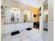 Bathroom with dual sinks and vanities, white cabinetry, and a mirrored closet at 3037 Crest Dr, Clearwater, FL 33759