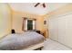 Bedroom featuring a ceiling fan, window, and large closet at 3037 Crest Dr, Clearwater, FL 33759