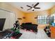 Bedroom featuring a ceiling fan, window, and tile floor at 3037 Crest Dr, Clearwater, FL 33759