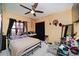 Bedroom featuring tile floors, a ceiling fan, and a window with black curtains at 3037 Crest Dr, Clearwater, FL 33759