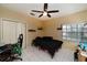 Bedroom featuring a ceiling fan, window, and tile floor at 3037 Crest Dr, Clearwater, FL 33759