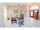 Bright dining area with tile floors, a glass-top table, and a view of the front entry at 3037 Crest Dr, Clearwater, FL 33759